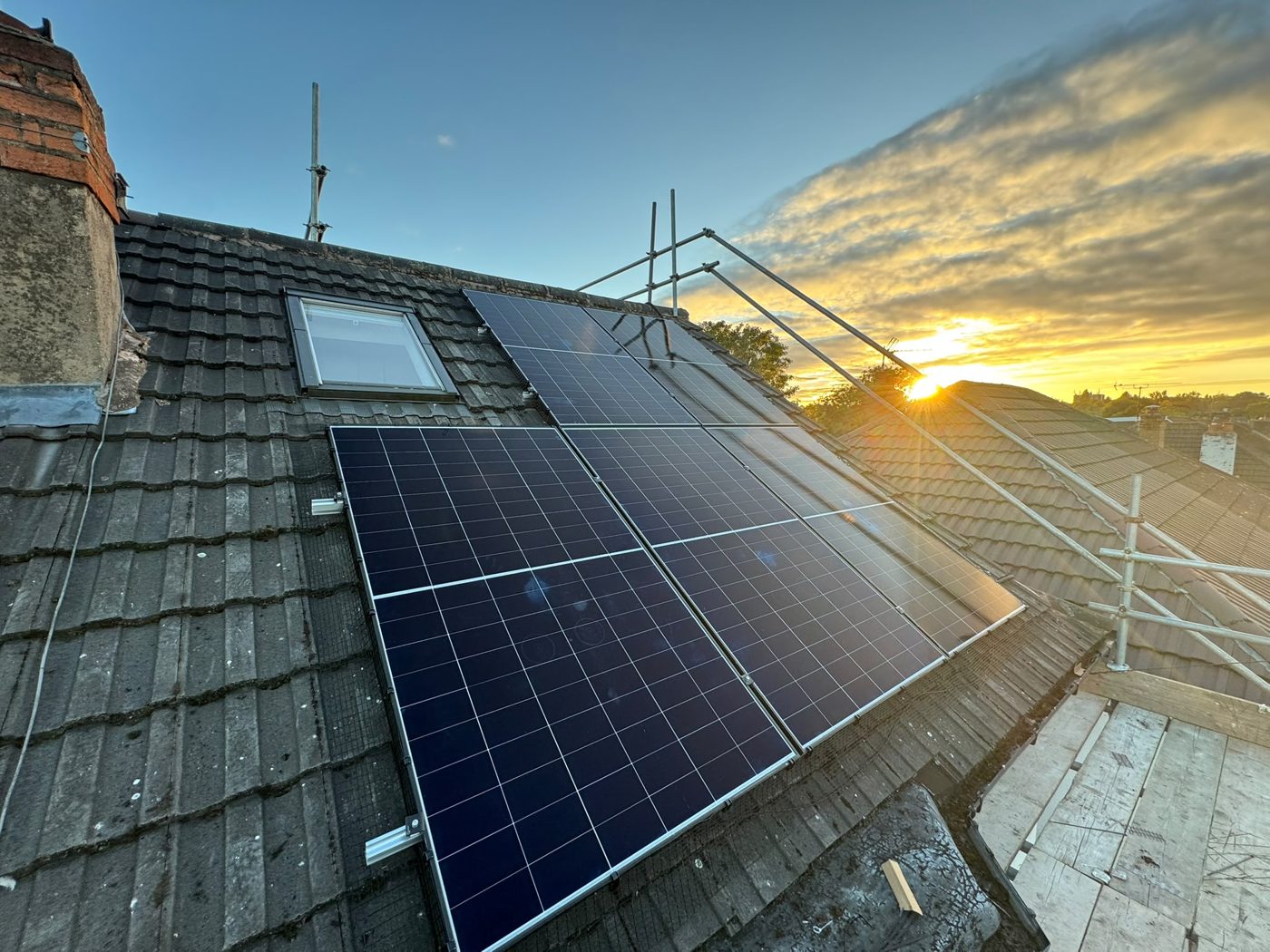 Solar panels on a UK roof at sunset